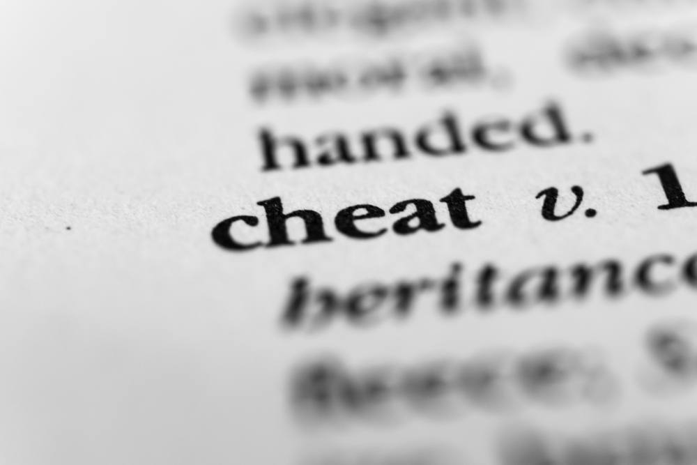 A page from the dictionary highlighting the word cheat.